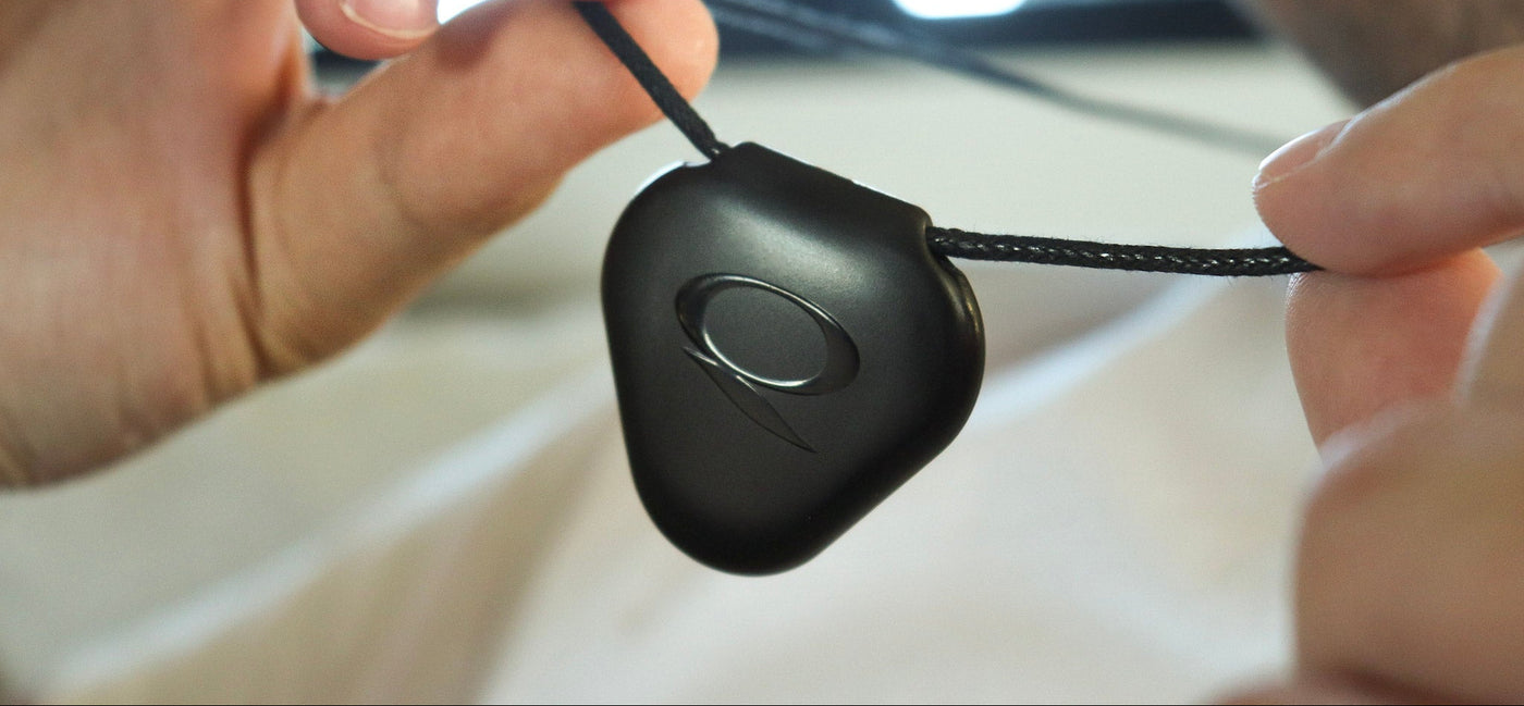 Close-up of a black Q-Link pendant for wearable resonance technology