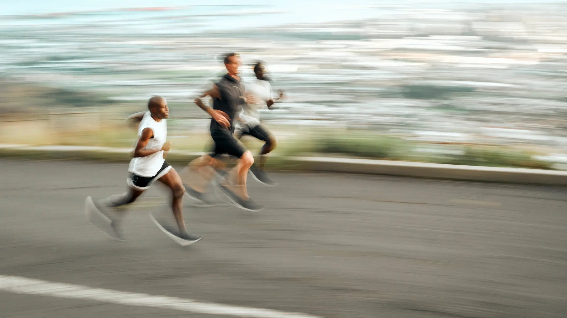 People running outdoors representing Q-Link mission, values, and human-centered wellness
