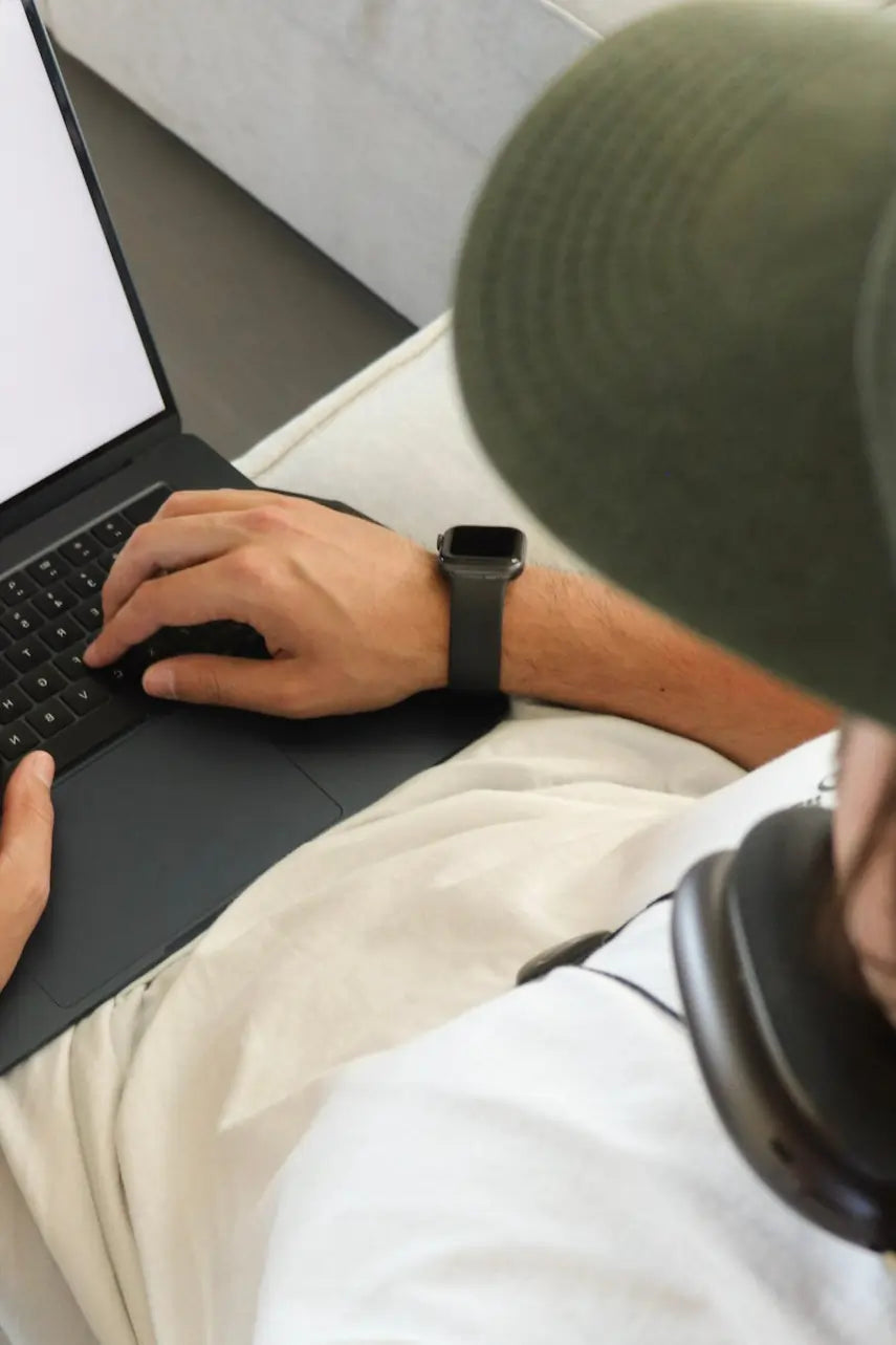 Person using a laptop for Q-Link focus and clarity in modern EMF environments